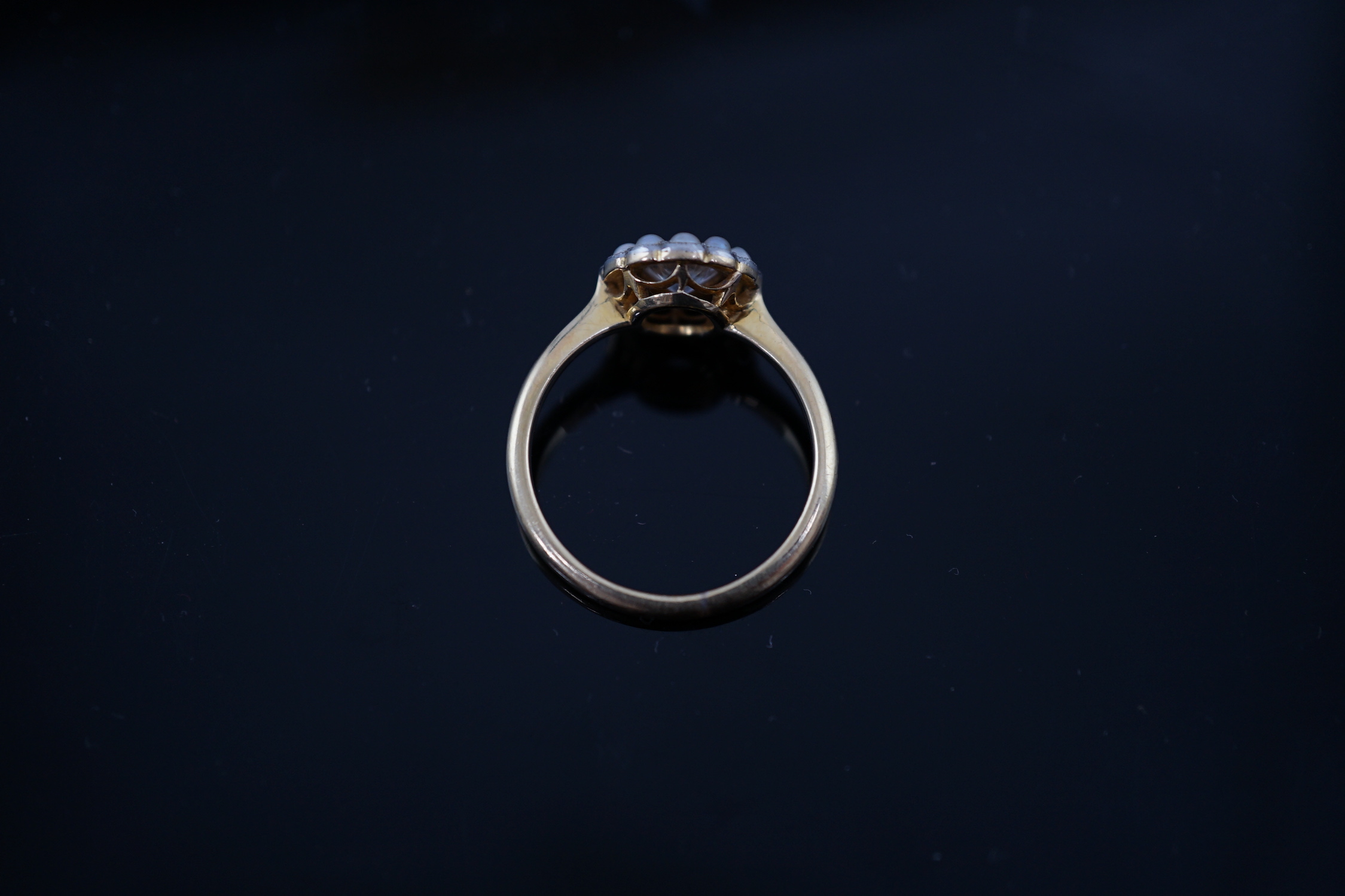 An early 20th century 18ct gold, diamond and millegrain set seed pearl circular cluster ring